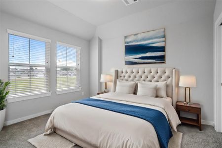 Secondary bedroom features plush carpet, custom paint and a large window with privacy blinds.