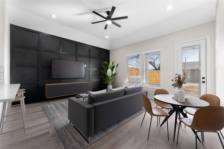 Living room with ceiling fan, light hardwood / wood-style floors, and a wealth of natural light