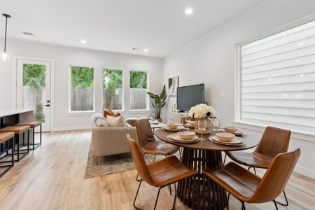 This living space boasts expansive windows inviting the outdoors in and illuminating the inviting living spaces.