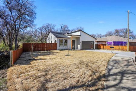 View of front facade featuring concrete driveway, an attached garage, fence private yard, and stucco siding