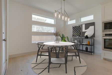 Dining area with light hardwood / wood-style flooring