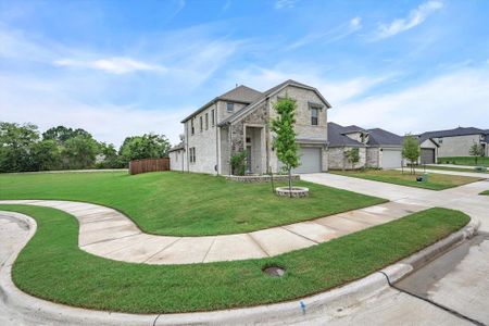 View of front of house featuring a front lawn and a garage