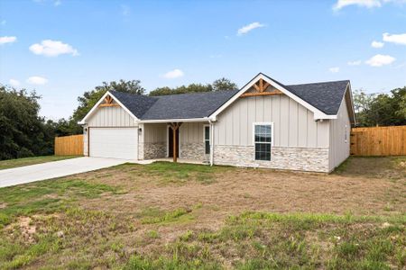 View of front of house with a front yard and a garage