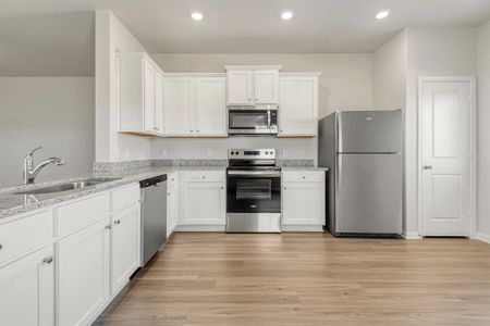 The kitchen is upgraded with Whirlpool appliances and granite countertops.