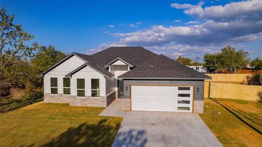 View of front facade with a front lawn and a garage