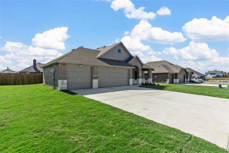 View of front facade with a garage and a front lawn