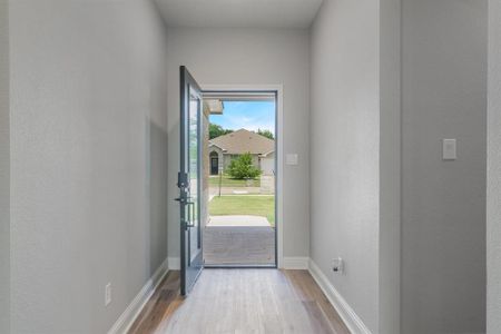 Doorway with a wealth of natural light and light hardwood / wood-style floors