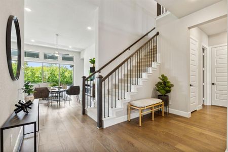 Staircase with ceiling fan and hardwood / wood-style floors