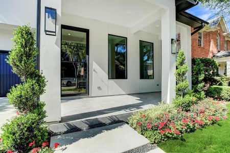 Inviting porch and designer front door greet you as you enter this lovely home.