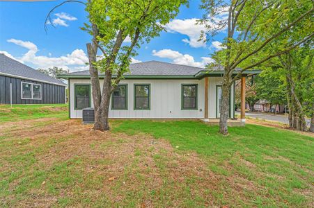 Back of house with a lawn and central AC