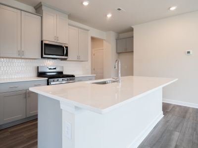 The well-appointed kitchen with a large island makes meal prep a breeze.