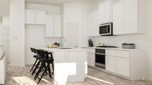 Kitchen featuring white cabinets, appliances with stainless steel finishes, a kitchen island with sink, and sink