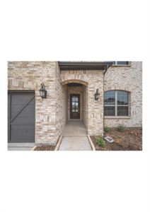 View of exterior entry with a garage