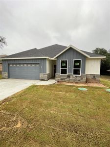 View of front of house with a front yard and a garage