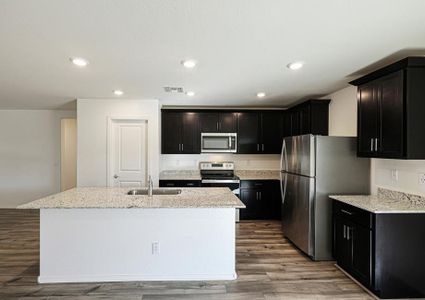 This kitchen has a beautiful granite island.