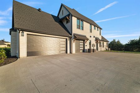 View of front of house with a garage and central AC