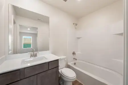 Full bathroom featuring wood-type flooring, toilet, vanity, and shower / washtub combination