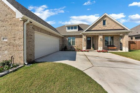 View of front facade featuring a front lawn and a garage