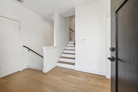 Enter the lower level of this home through your front door at the top of the stairs. You are welcomed with beautiful blond wood floors.