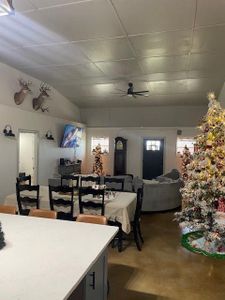 Dining room featuring ceiling fan and a drop ceiling