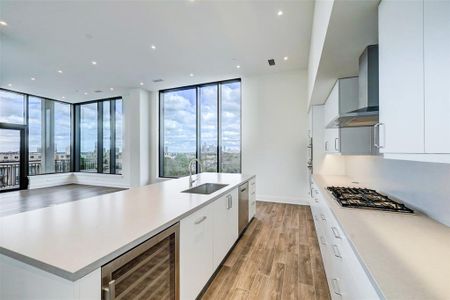 The expansive great room sets the stage for lavish entertaining with a generous footprint for living and dining areas surrounded by bold columns and the home's signature views.