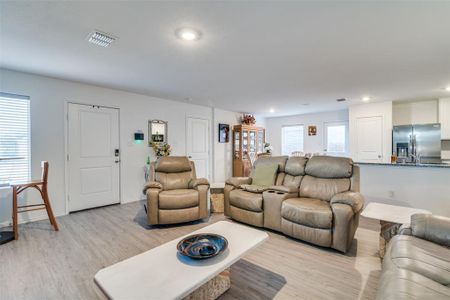 Living room with light hardwood / wood-style flooring