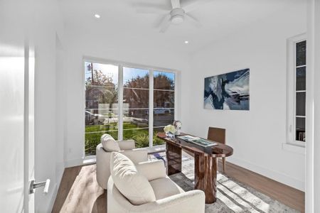 Office space featuring ceiling fan and wood-type flooring