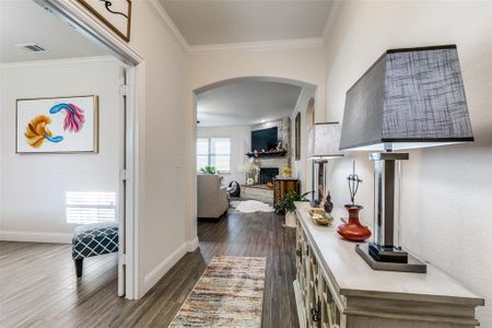 Corridor featuring dark hardwood / wood-style floors and crown molding