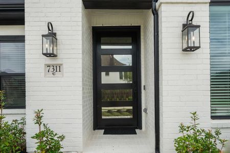 Approaching the front door you will see the spacious front porch with beautiful contrasting painted brick and trim. It's completed with modern iron lanterns, an 8 ft front door, keyless entry, and smart door bell! Home comes fully equipped with cameras and a security system.