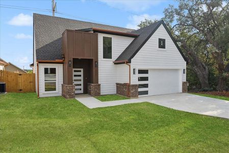 View of front of house with a front lawn, central AC unit, and a garage