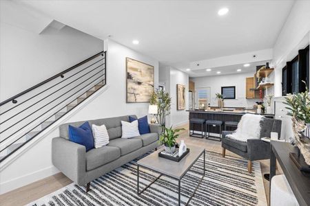 Living room with recessed lighting, stairway, baseboards, and light wood-style flooring