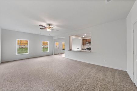 Living room featuring light carpet and ceiling fan