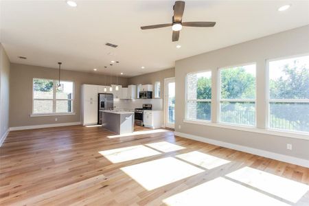 Unfurnished living room with light hardwood / wood-style flooring and ceiling fan