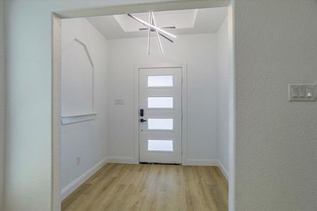 Foyer featuring a chandelier and light hardwood / wood-style floors