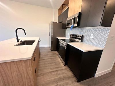 Upgraded cabinetry and lighting, quartz countertops, and wooden slats