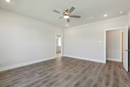 Unfurnished room with ceiling fan and light hardwood / wood-style floors