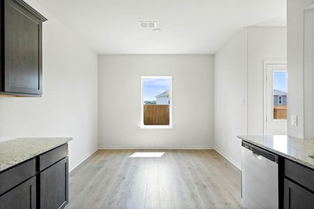 Dining area with light wood-style floors