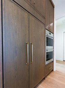 Gorgeous wood paneled 42" Sub-Zero refrigerator with double convection oven.