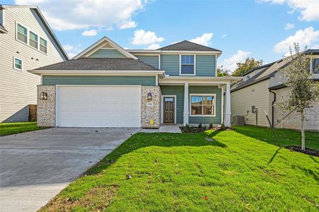 View of front of house with a front yard, a garage, and central air condition unit