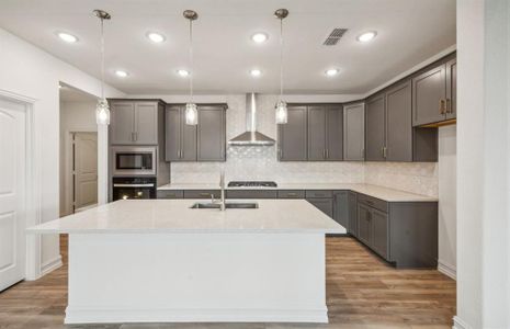 Bright kitchen with oversized island *real home pictured