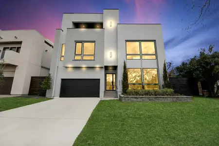 This stunning modern home makes an unforgettable impression with its sleek lines, striking architecture, and vibrant exterior lighting. The dramatic windows allow natural light to flood the interior while offering a glimpse of its contemporary elegance. The well-manicured lawn and clean driveway add to the home's polished curb appeal, making it a perfect blend of style and sophistication.