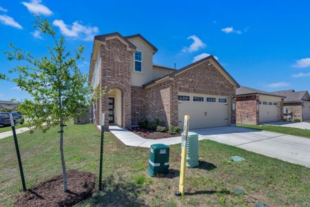View of front facade with brick siding, driveway, an attached garage, and a front lawn View of front facade with brick siding, driveway, an attached garage, and a front lawn