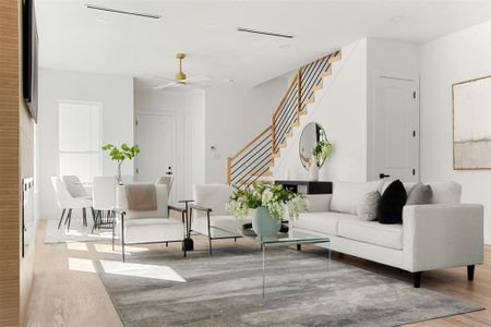 Living room featuring ceiling fan and wood-type flooring