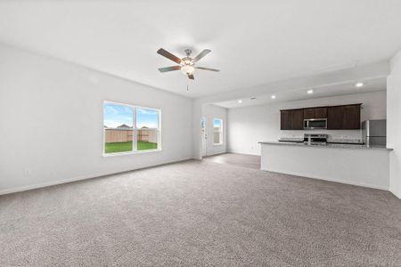 Living room featuring light carpet and ceiling fan