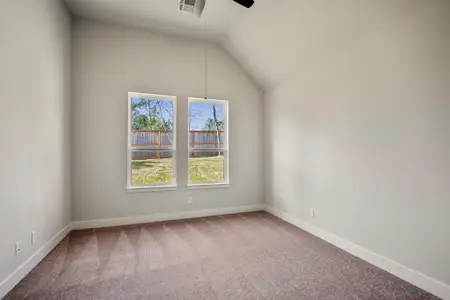 This secondary bedroom with plush carpeting and high ceilings, invites you to explore endless possibilities and make it truly your own haven of comfort.