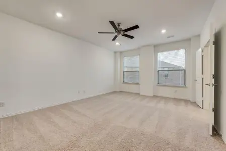 Carpeted empty room with ceiling fan