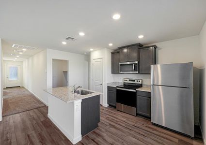 Enjoy stunning granite countertops and designer wood cabinetry in this kitchen.