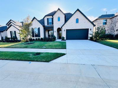 French country inspired facade featuring a front yard