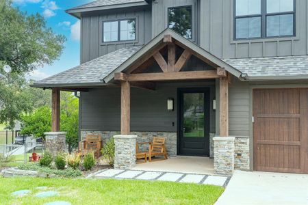 Entrance to property featuring a garage and covered porch