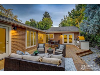 Private back patio with custom outdoor kitchen featuring Napoleon appliances and Ciao Pizza Oven